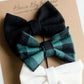 Little girls hair bow set of three. This shows a white, black and green buffalo check headband or alligator clip bow.