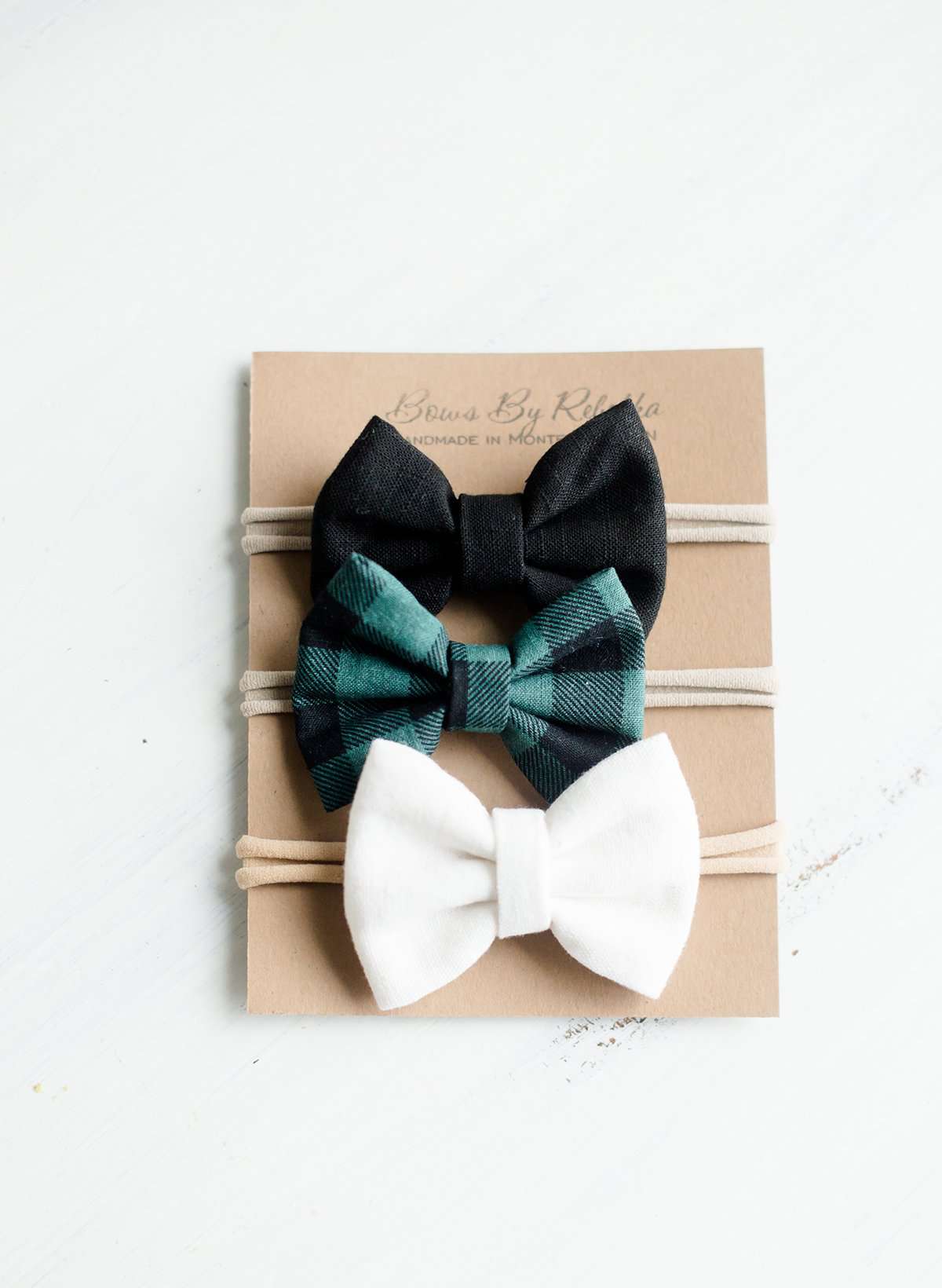 Little girls hair bow set of three. This shows a white, black and green buffalo check headband or alligator clip bow.