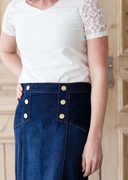 woman wearing a modest below the knee button accent denim jean skirt with no slit