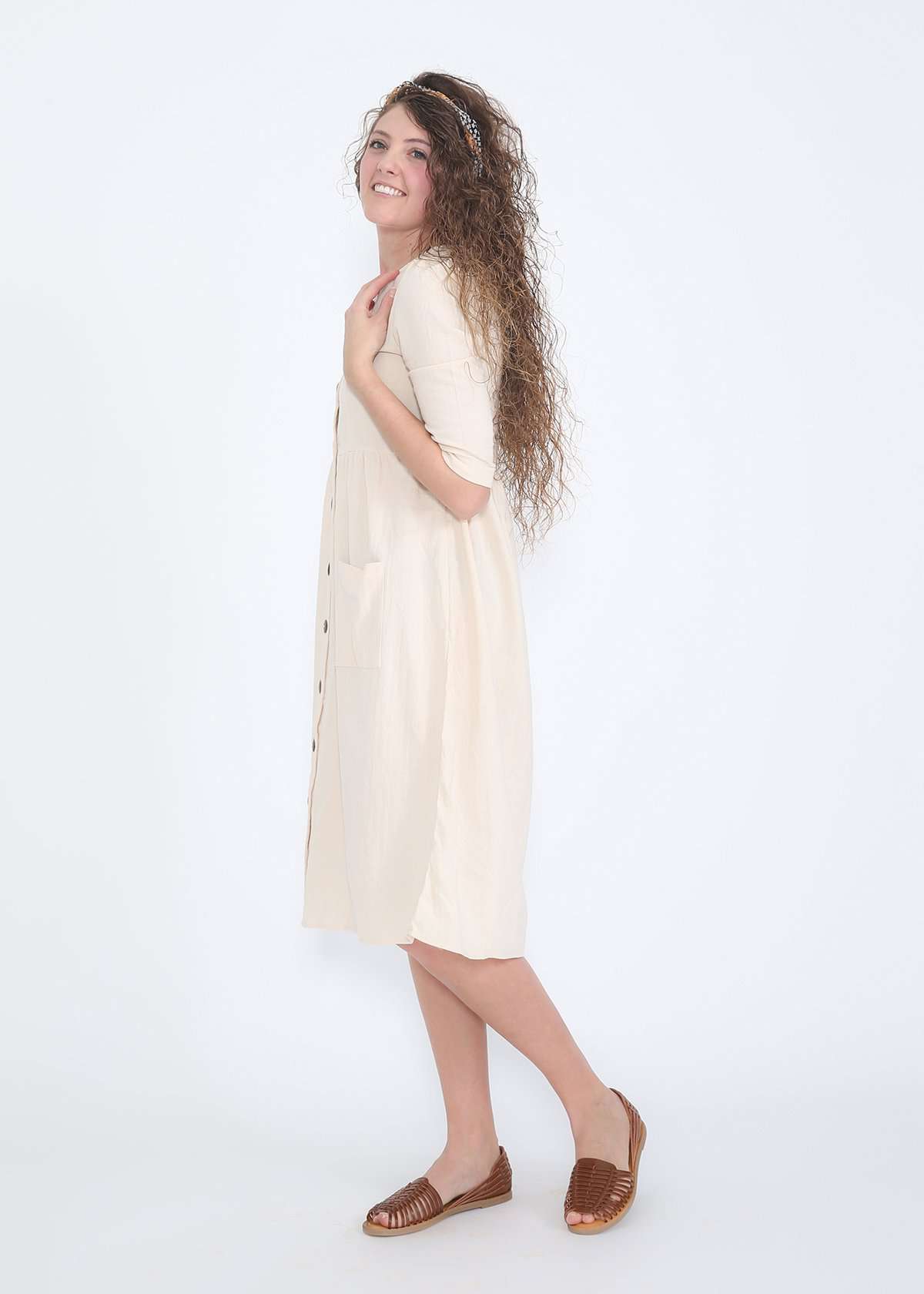 Modest women's cream cotton dress with brown buttons and half sleeves