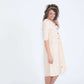 Modest women's cream cotton dress with brown buttons and half sleeves