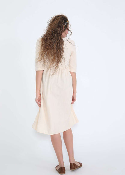Modest women's cream cotton dress with brown buttons and half sleeves