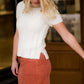 This is a mock neck cable knit short sleeve sweater in ivory.