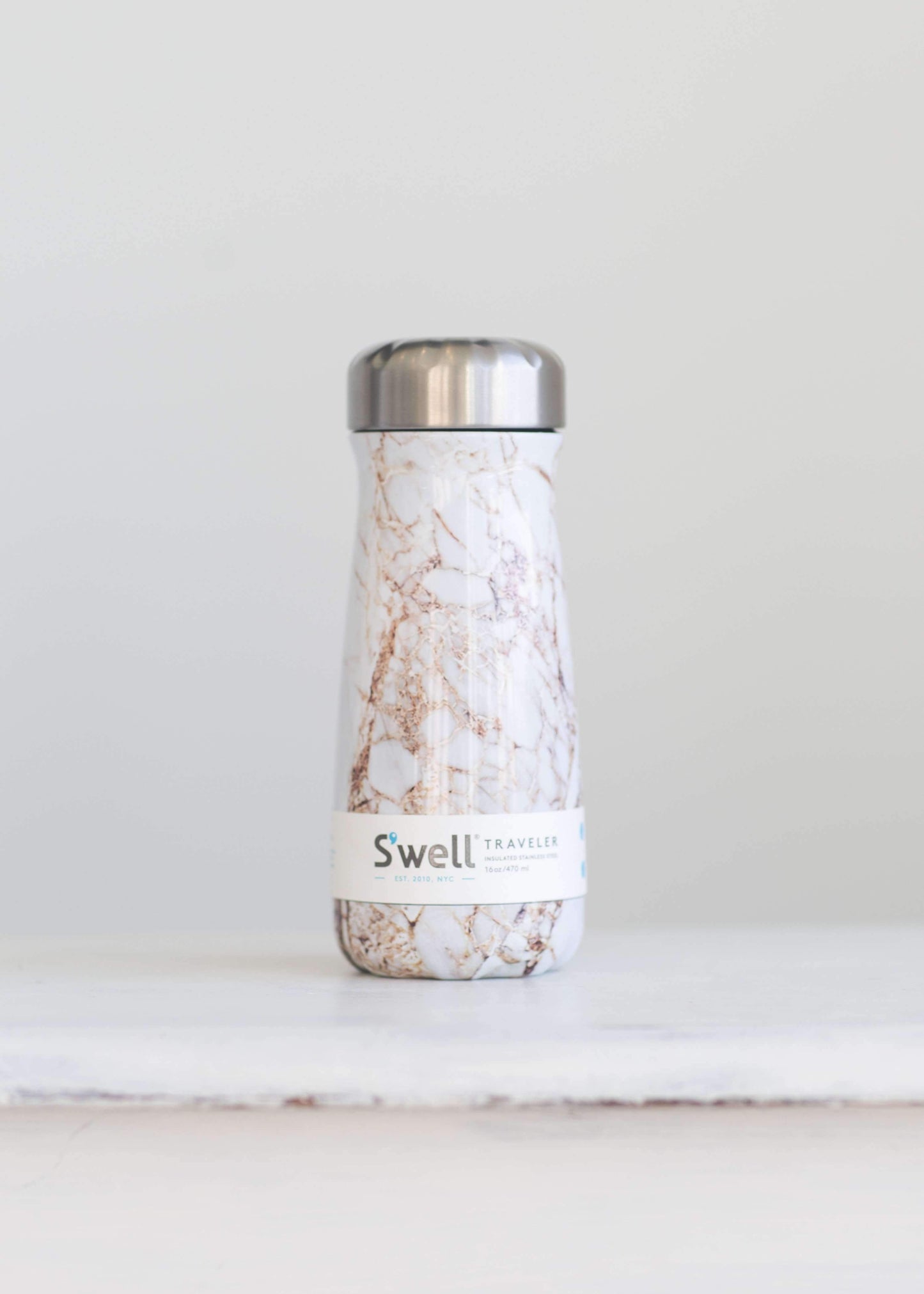 S'well water bottle in a gold and marble design and holds 16 oz.