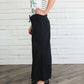 Black, tan or olive option in this long skirt with drawstring waist and side strings to adjust height from midi to maxi