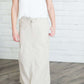 Black, tan or olive option in this long skirt with drawstring waist and side strings to adjust height from midi to maxi