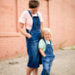 woman in a modest denim overall jumper dress