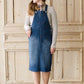 woman in a modest denim overall jumper dress