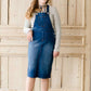 woman in a modest denim overall jumper dress