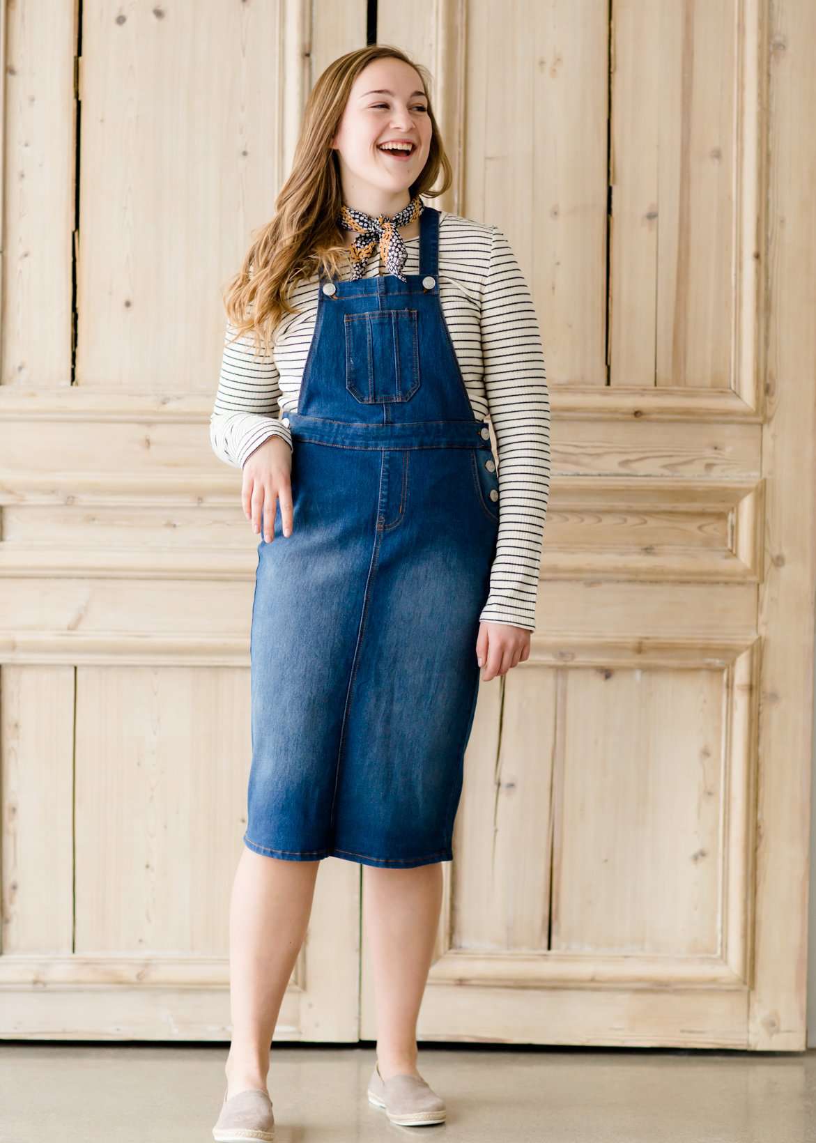 woman in a modest denim overall jumper dress