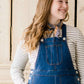 woman in a modest denim overall jumper dress