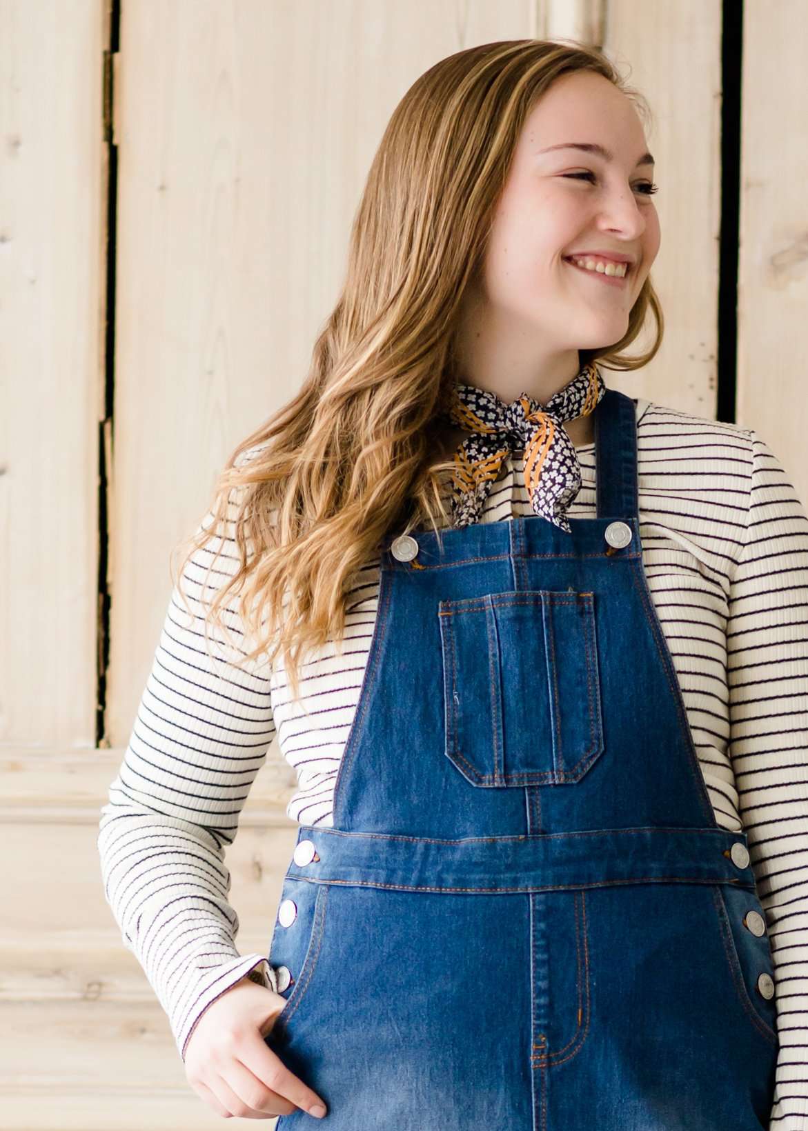 woman in a modest denim overall jumper dress