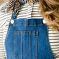 woman in a modest denim overall jumper dress