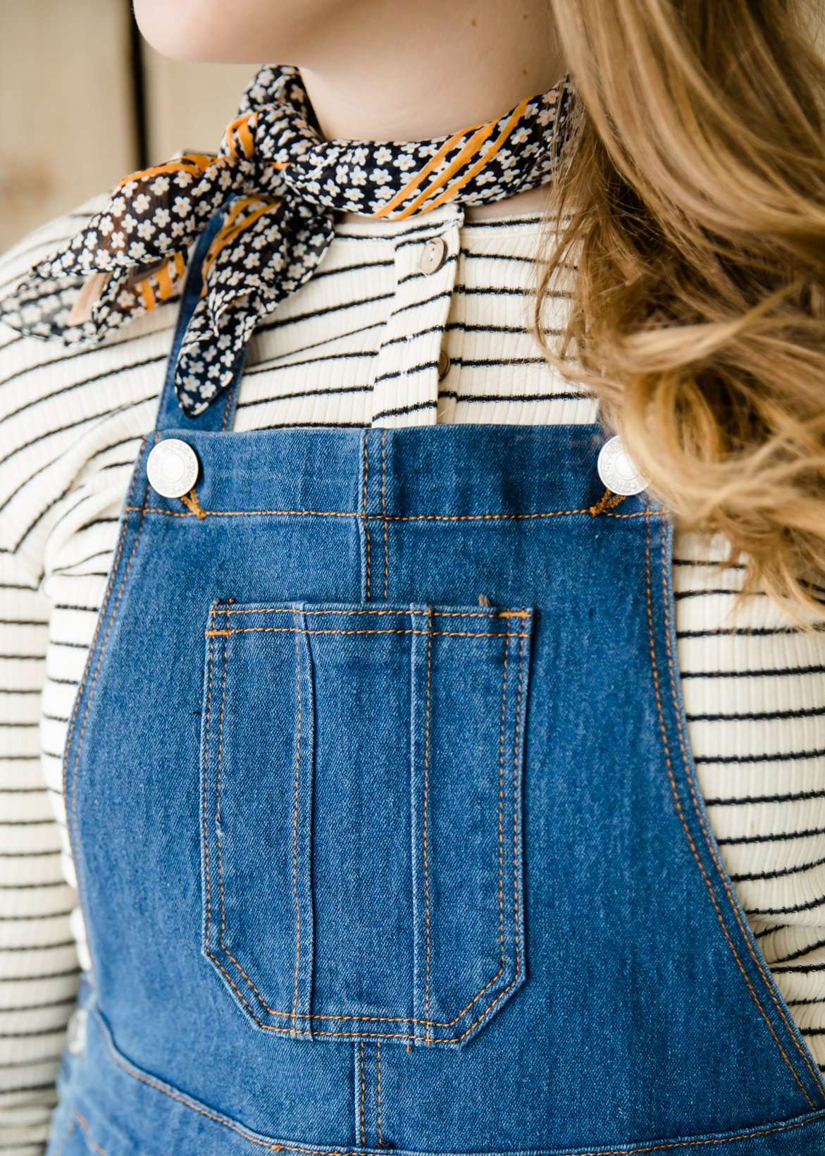 woman in a modest denim overall jumper dress