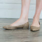 Blush or taupe casually detailed and patterned flat shoe with pointed toe.