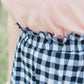 Black and white checkered below the knee skirt with elastic ruffle waistband.