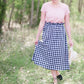 Black and white checkered below the knee skirt with elastic ruffle waistband.