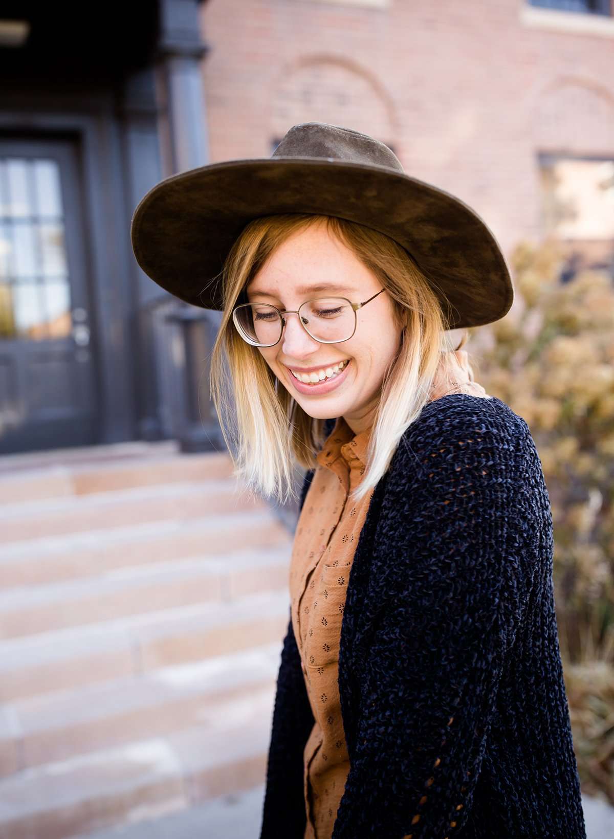 Young girl wearing a black long chenille sweater with front pockets and a cozy fit