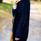 Young girl wearing a navy long chenille sweater with front pockets and a cozy fit