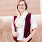Woman wearing a chenille style snood scarf. This cowl like scarf comes in cream or taupe.