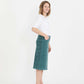 Woman wearing a below the knee corduroy skirt. This skirt is a fin corduroy with a gold button snap, no slit and no back pockets. It comes in burgundy, teal, burnt orange and dark khaki.