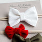 Little girls hair bow set of three. This shows a white, green and red velvet headband on a nylon band.