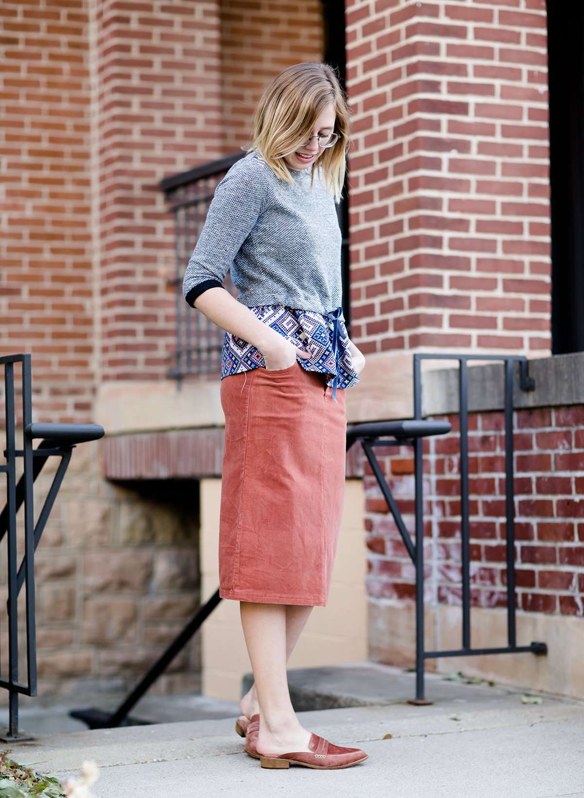 Woman wearing a classic copper colored backless genuine leather loafer