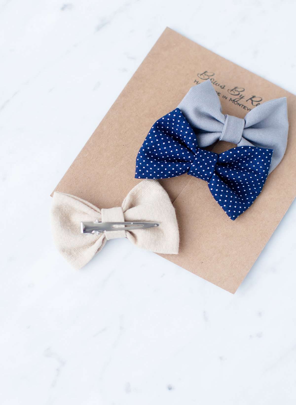 Little girls hair bow set of three. This shows a gray, taupe and navy polka dot headband or alligator clip bow.