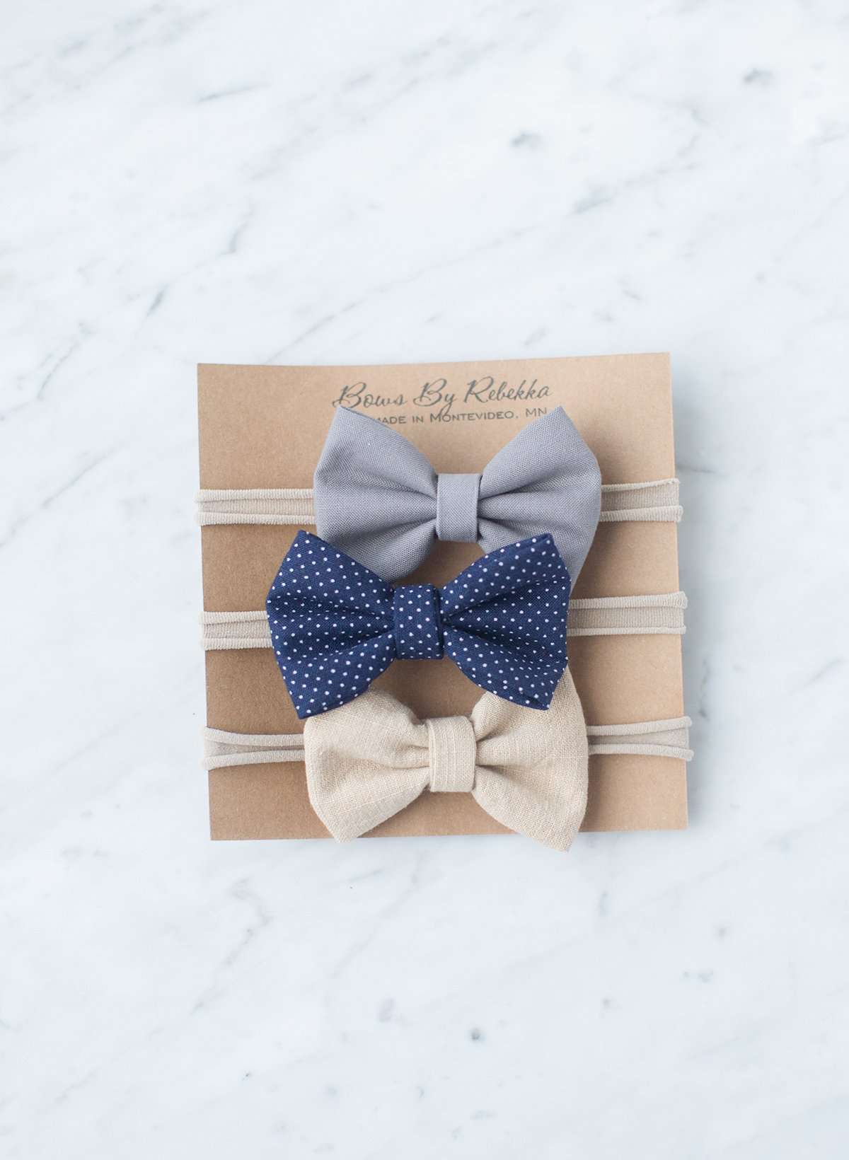 Little girls hair bow set of three. This shows a gray, taupe and navy polka dot headband or alligator clip bow.
