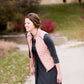Woman wearing a cold weather, quilted puffer vest. This vest comes in mauve, black, navy and wine. It features pockets and a front zip.