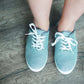 grey and white striped sneaker with white sole and laces.