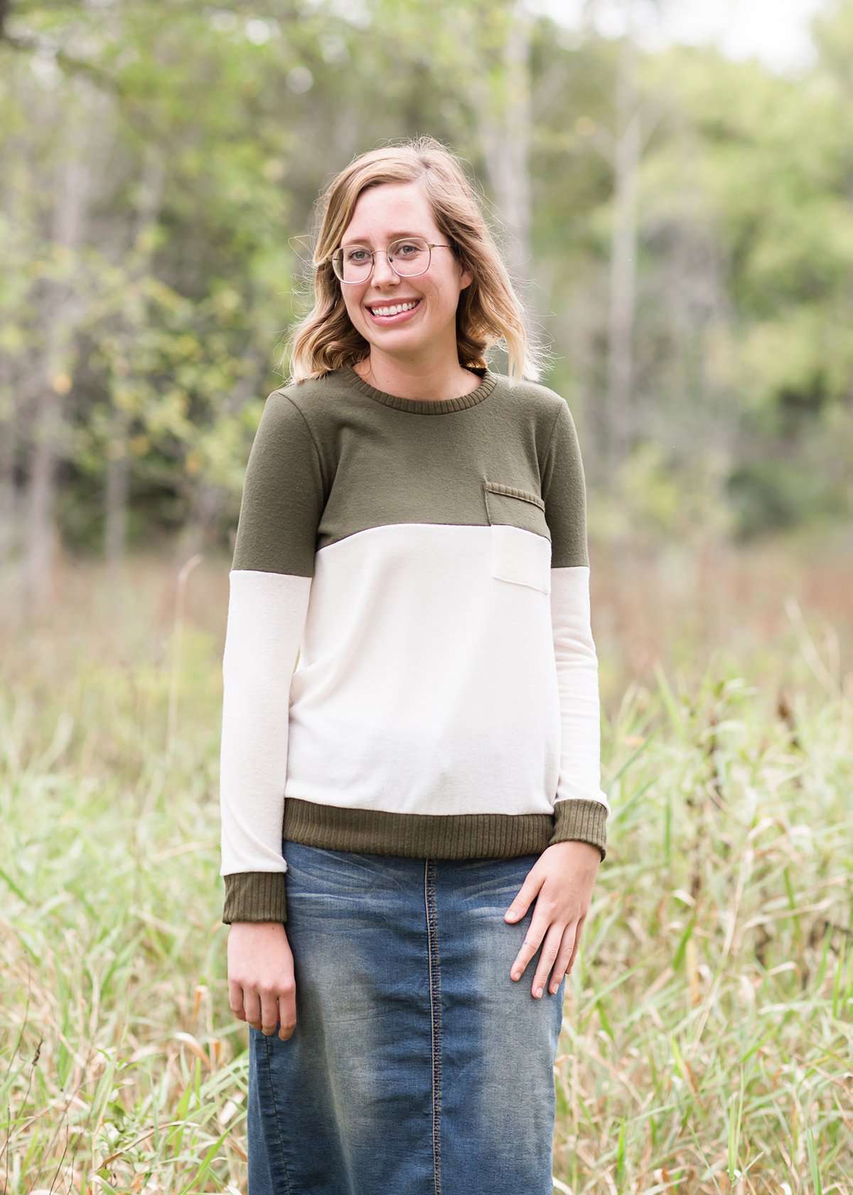 oatmeal colored sweater with olive stripe block top and front pocket.