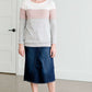 woman wearing a modest, soft sweater that is color blocked with white, mauve and gray.