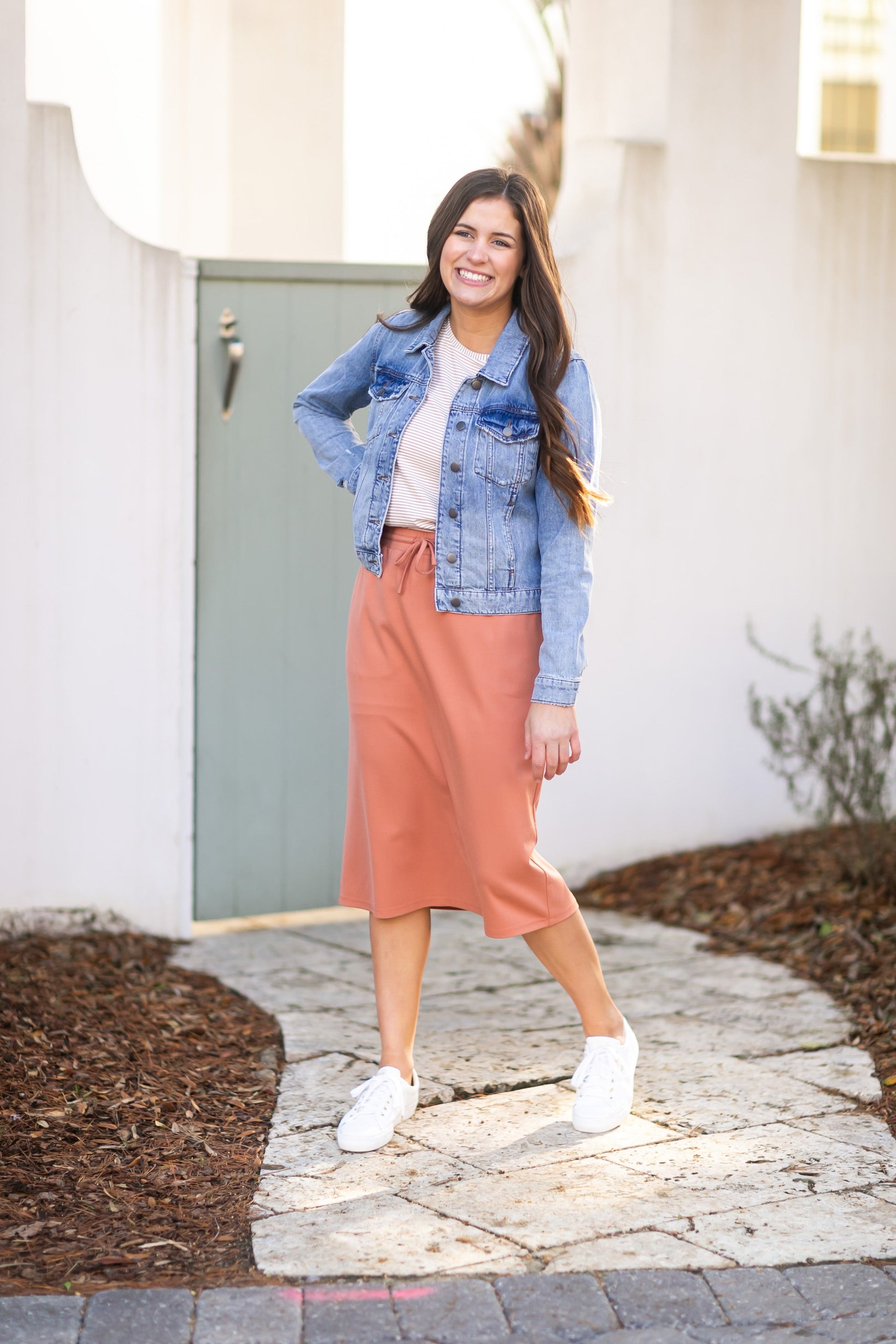 A modest salmon pink midi skirt . Featuring a a straight fit, pockets, and a drawstring waist.