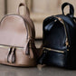 black or taupe small leather backpack purse.