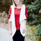 Woman wearing a rust colored, modest bell sleeve top. The 3/4 sleeves flutter and the top is also lined.