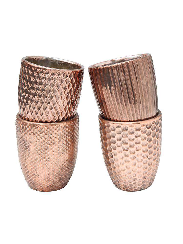 Set of four copper candle holders with a hammered tin design on each one