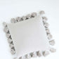 gray textured cotton throw pillow with tassels