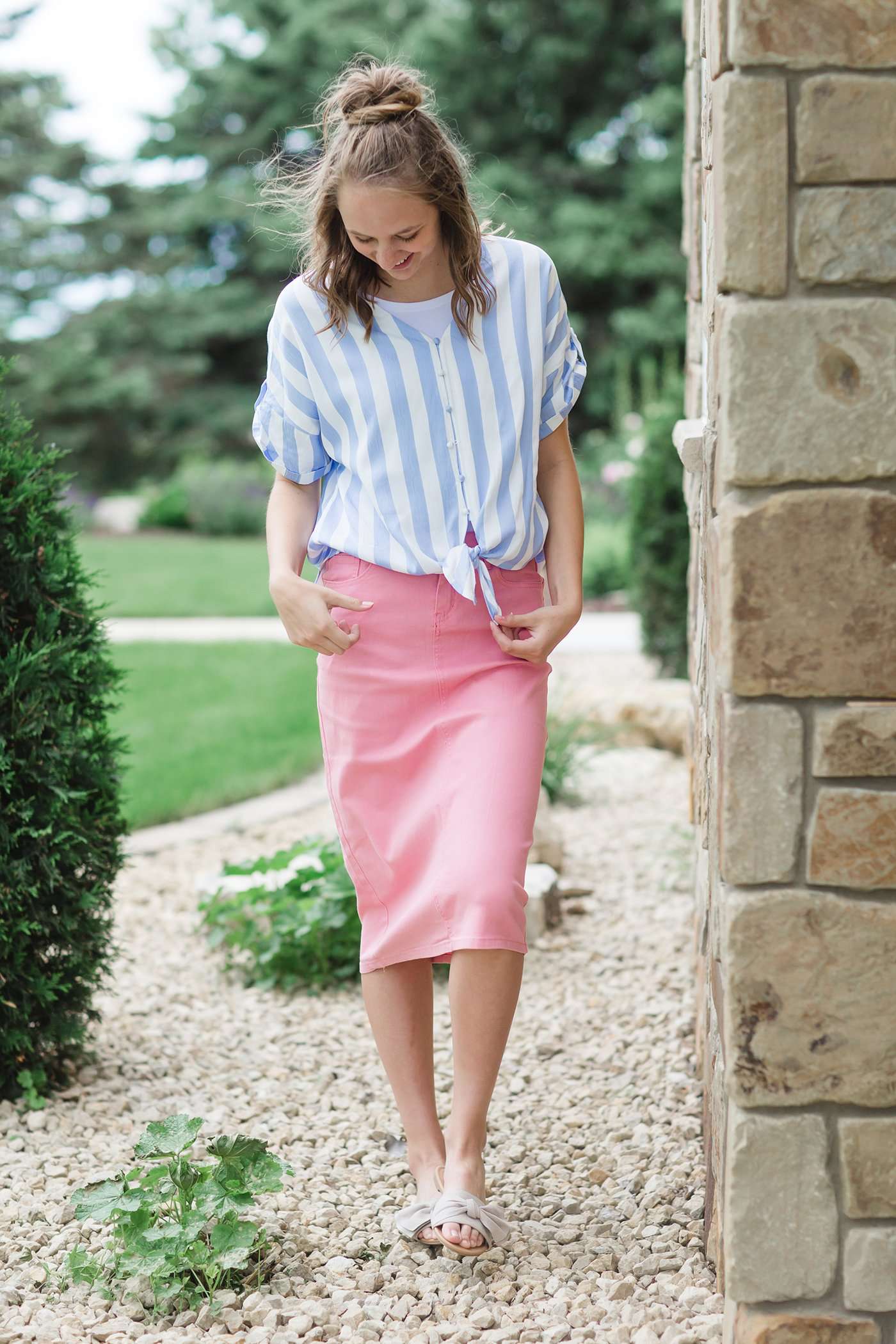 Blue and white vertical stripe top with short roll up sleeves and a tie front. Buttons up the front to a v-neck.