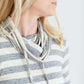 Woman wearing a modest gray and white striped cowl neck pullover top.