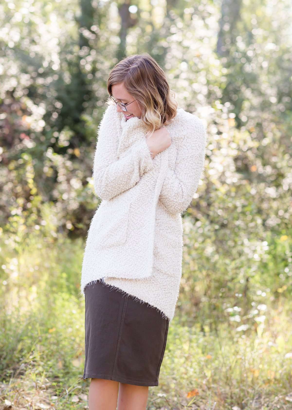 Women's cozy long vanilla cardigan with clasp close front and two side pockets.