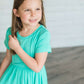 coral or mint colored short sleeve girls maxi dress with crochet detail at the bottom and elastic waist.