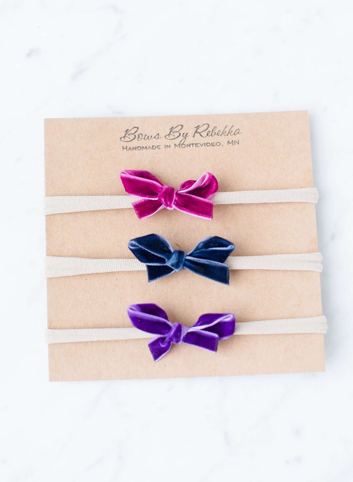 Baby girls velvet hand tied bows. Three bows in this set and they are magenta, navy and purple.