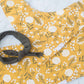 This is a mustard colored baby burp cloth, baby bandana and headband gift set.