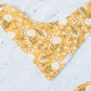 This is a mustard colored baby burp cloth, baby bandana and headband gift set.