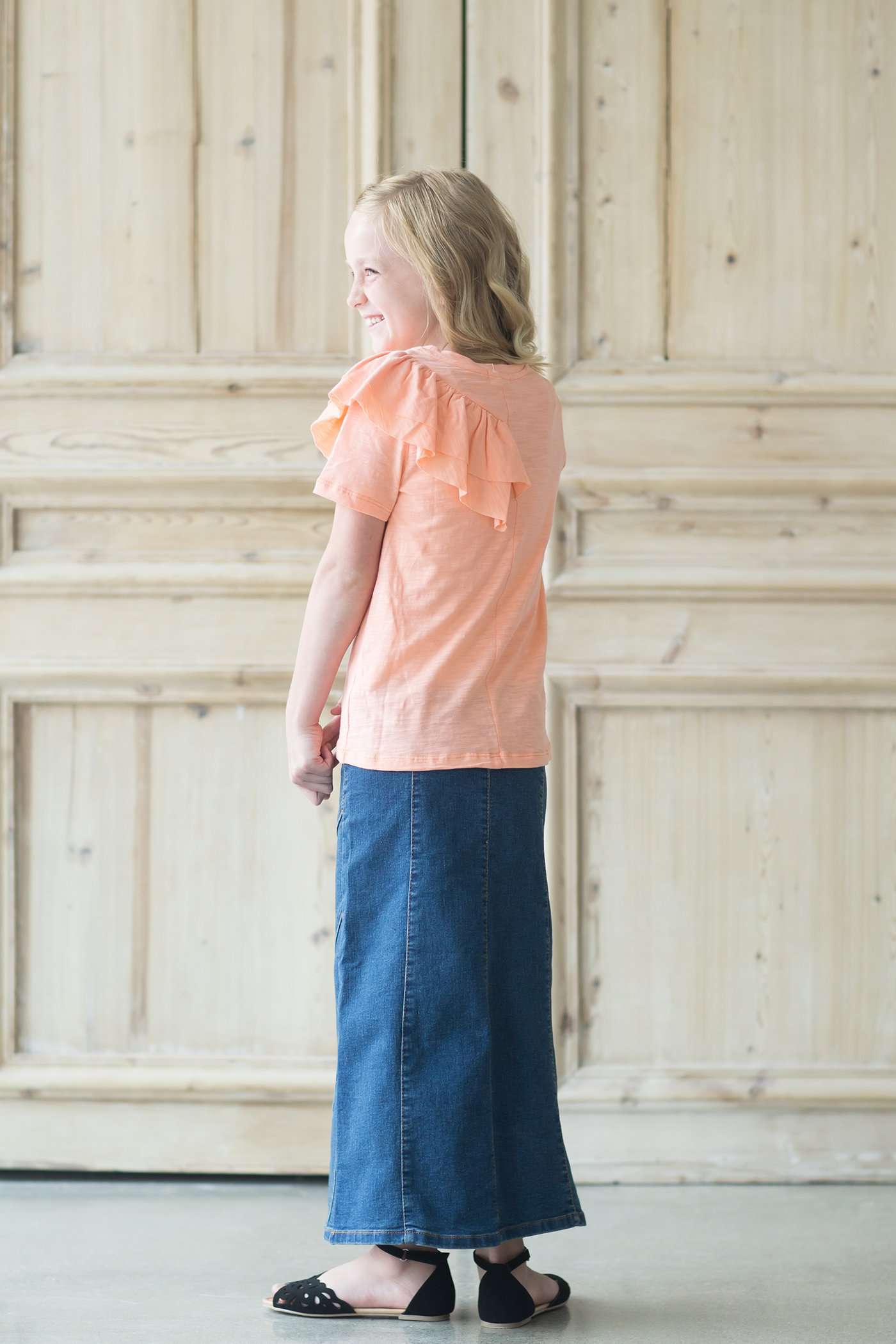 Girl's denim a-line maxi skirt with diagonal detailing across the front and elastic waistband.