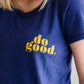 Young woman wearing a blue graphic tee with yellow words that says "Do Good." It is also paired with a below the knee denim skirt and a plaid button up top.