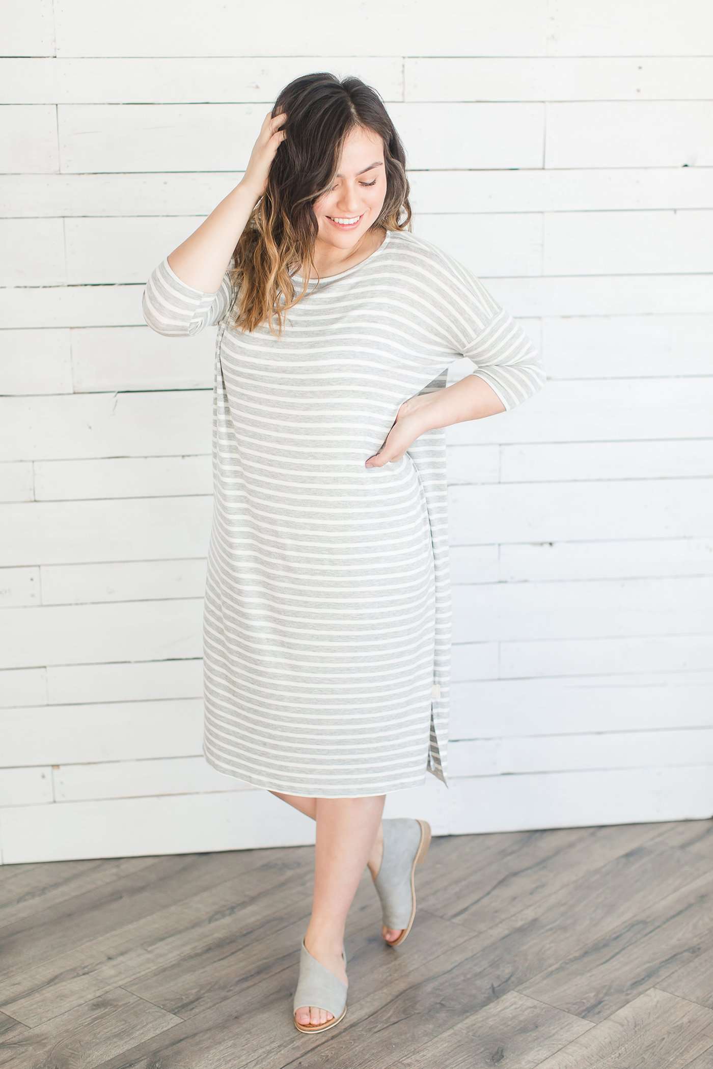 grey and white striped three quarter length sleeve midi dress with a modest crew neck top and side slit.