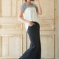 Woman wearing a modest long black denim skirt with pockets