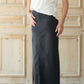 Woman wearing a modest long black denim skirt with pockets